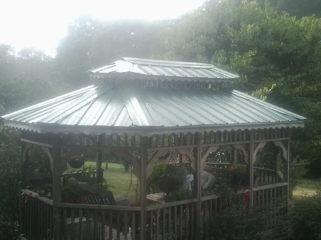 Two tier green metal roof on a garden gazebo in Crystal City